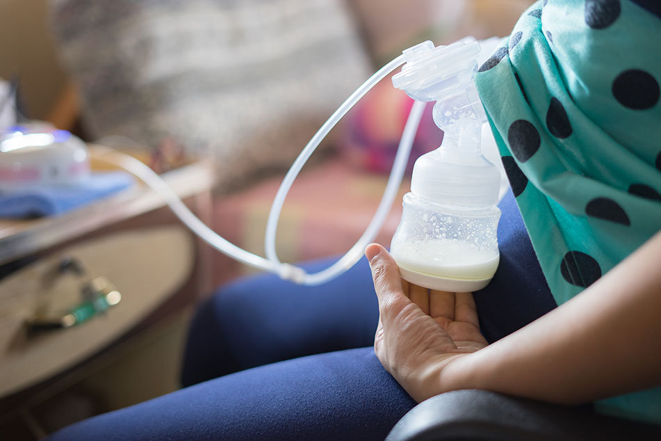 Breast pump expressing milk into bottle