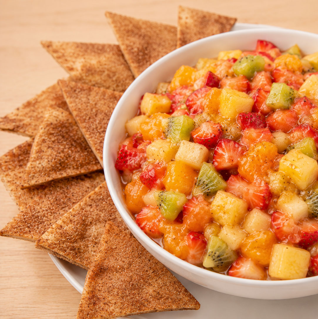 Fruit salsa with cinnamon tortilla chips arranged around