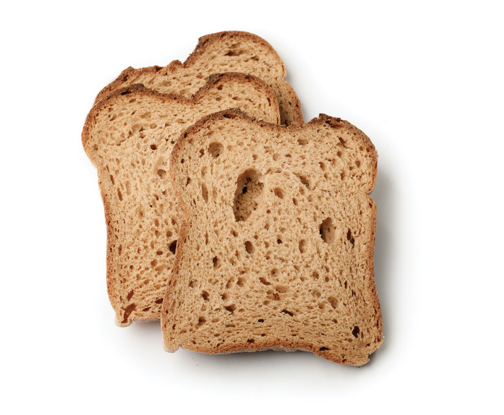 Three slices of brown bread stacked